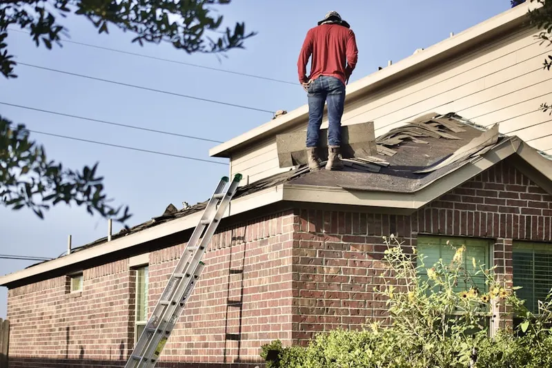 Professional roofer working on a residential roof in Windmill Harbor